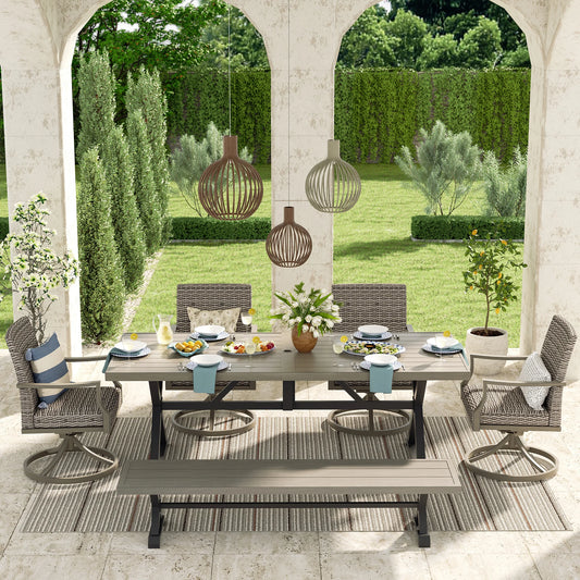 Outdoor patio set with table, chairs, and decorations in a garden setting.