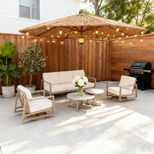 Outdoor patio set with furniture, umbrella, and string lights on a concrete patio.