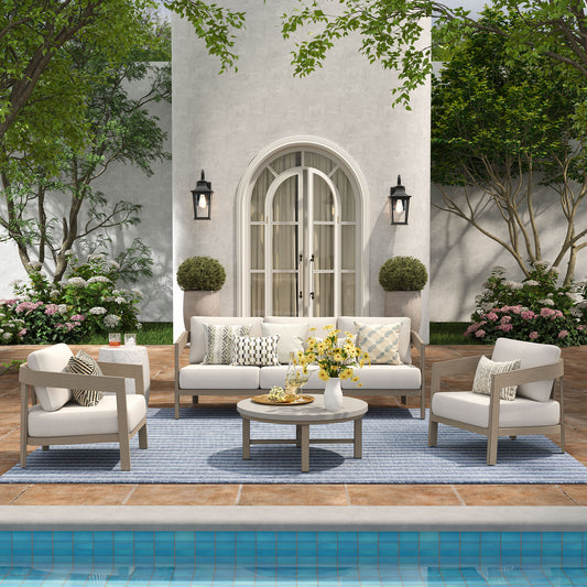 Outdoor patio set with white furniture by a poolside