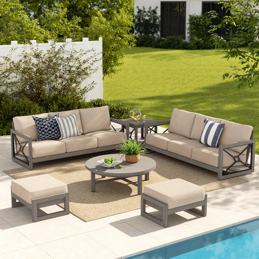 Outdoor patio Sectional set with beige cushions and gray frames by a pool.