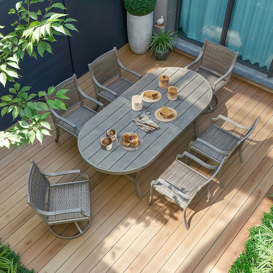 Outdoor dining set with table and chairs on a wooden deck, surrounded by plants.