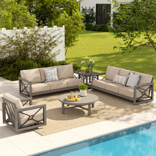 Outdoor patio furniture set with beige cushions by a pool
