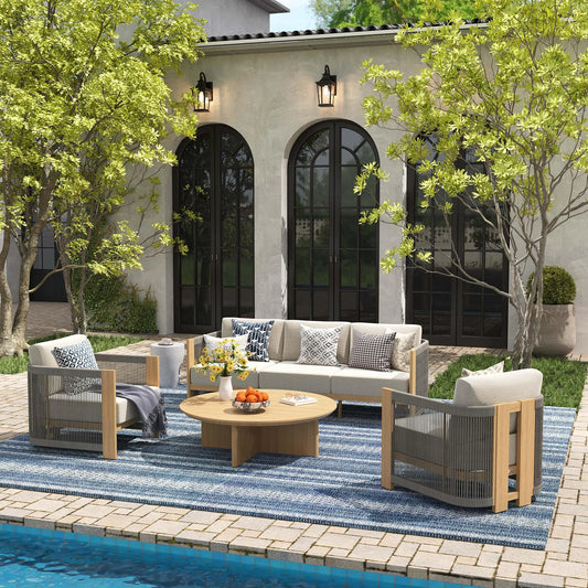 Outdoor patio set with furniture and decor by a poolside.