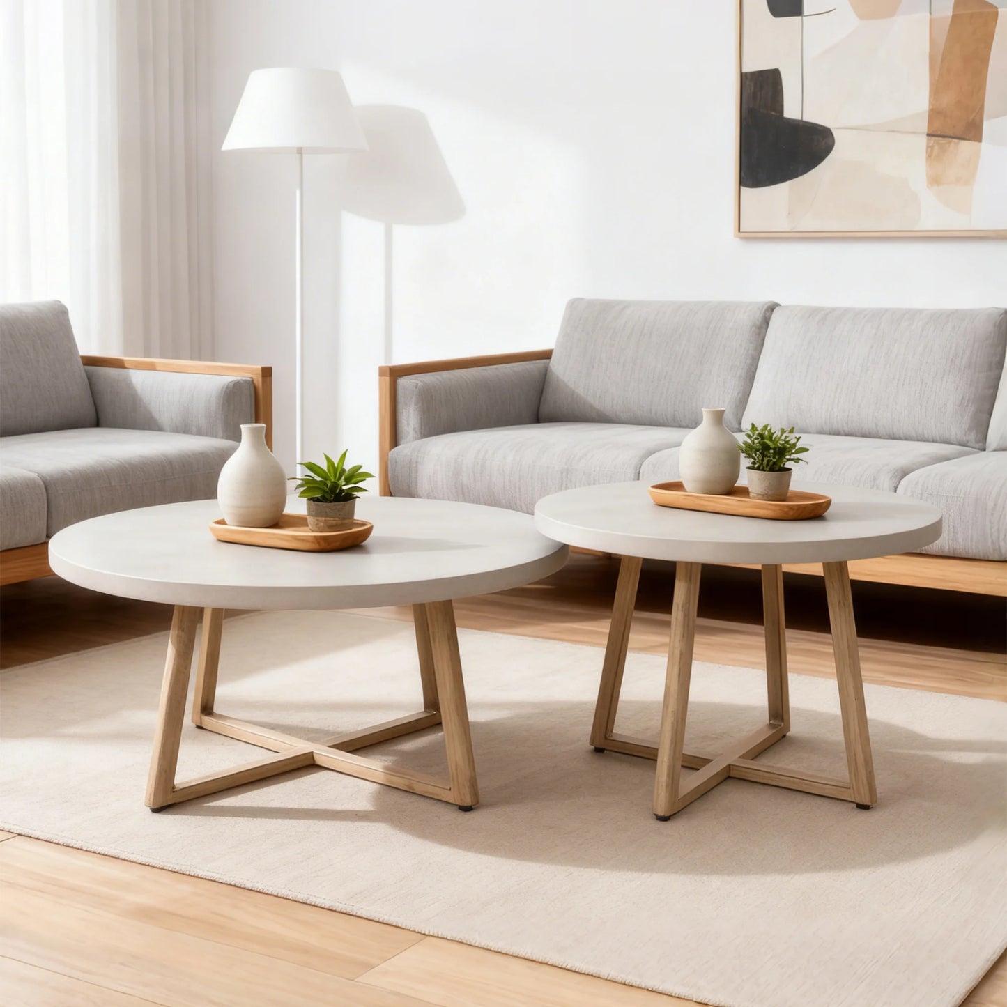 Modern living room with two round coffee tables and gray sofas.