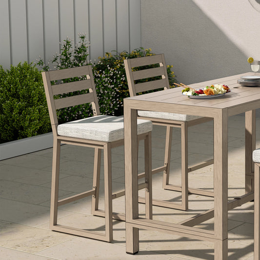 Outdoor dining set with wooden table and chairs on a patio.