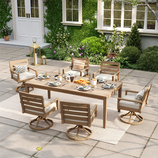 Alcudia 7-piece outdoor dining set with a rectangular faux wood table and six premium 360-degree swivel rocker chairs styled on a warm backyard stone patio.