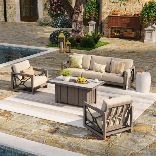 Marindo 4-piece luxury outdoor conversation set with beige cushions and faux-wood aluminum frames, arranged with a covered fire pit table on a patterned rug by a poolside patio during the day.