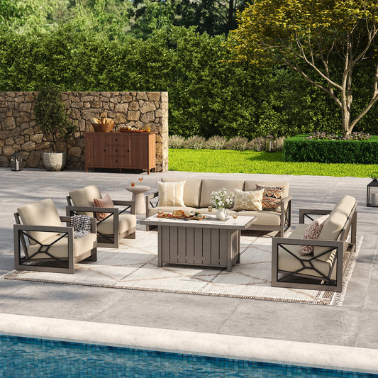 A bright resort-style patio providing backyard gathering inspiration, showcasing the Marindo 8-piece wood-look aluminum salon set with structured club chairs and beige cushions during the day.