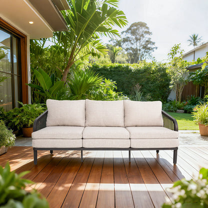Outdoor sofa on a wooden deck with lush greenery in the background