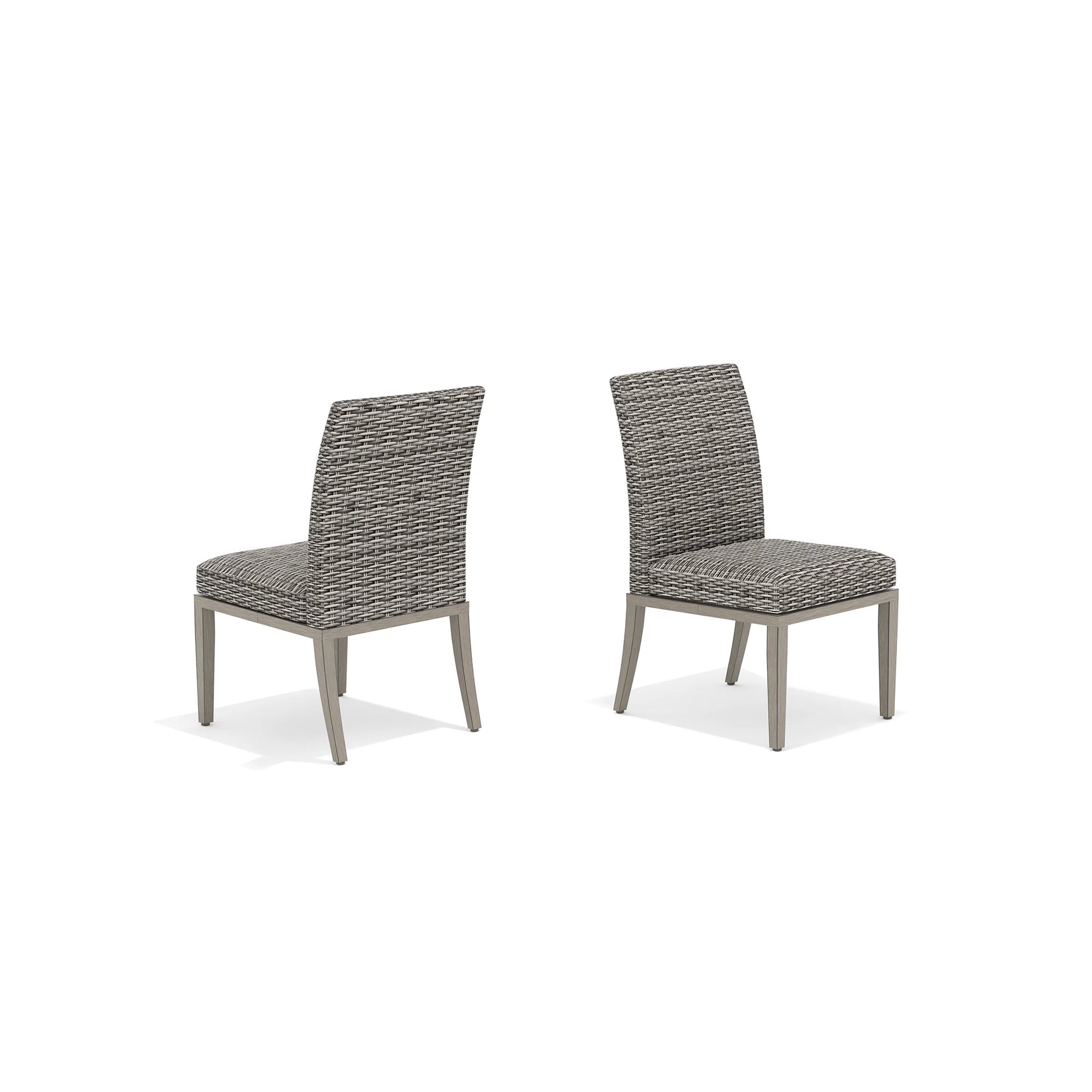 Two gray wicker chairs with cushions 