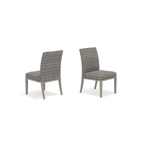 Two gray wicker chairs with cushions 