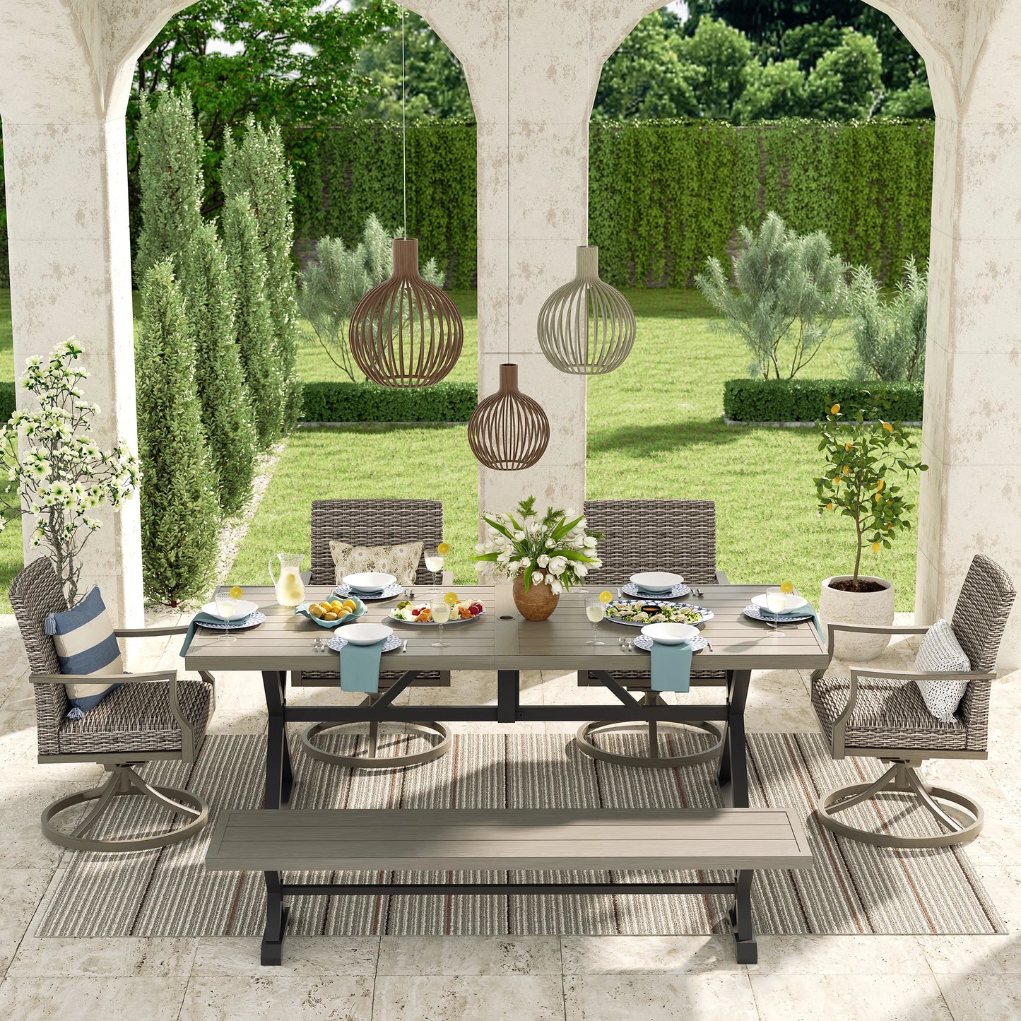 Outdoor patio set with table, chairs, and decorations in a garden setting.