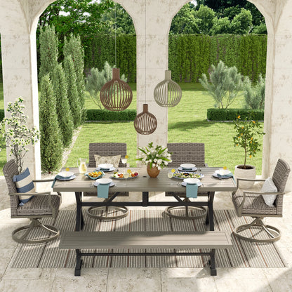 Outdoor patio set with table, chairs, and decorations in a garden setting.