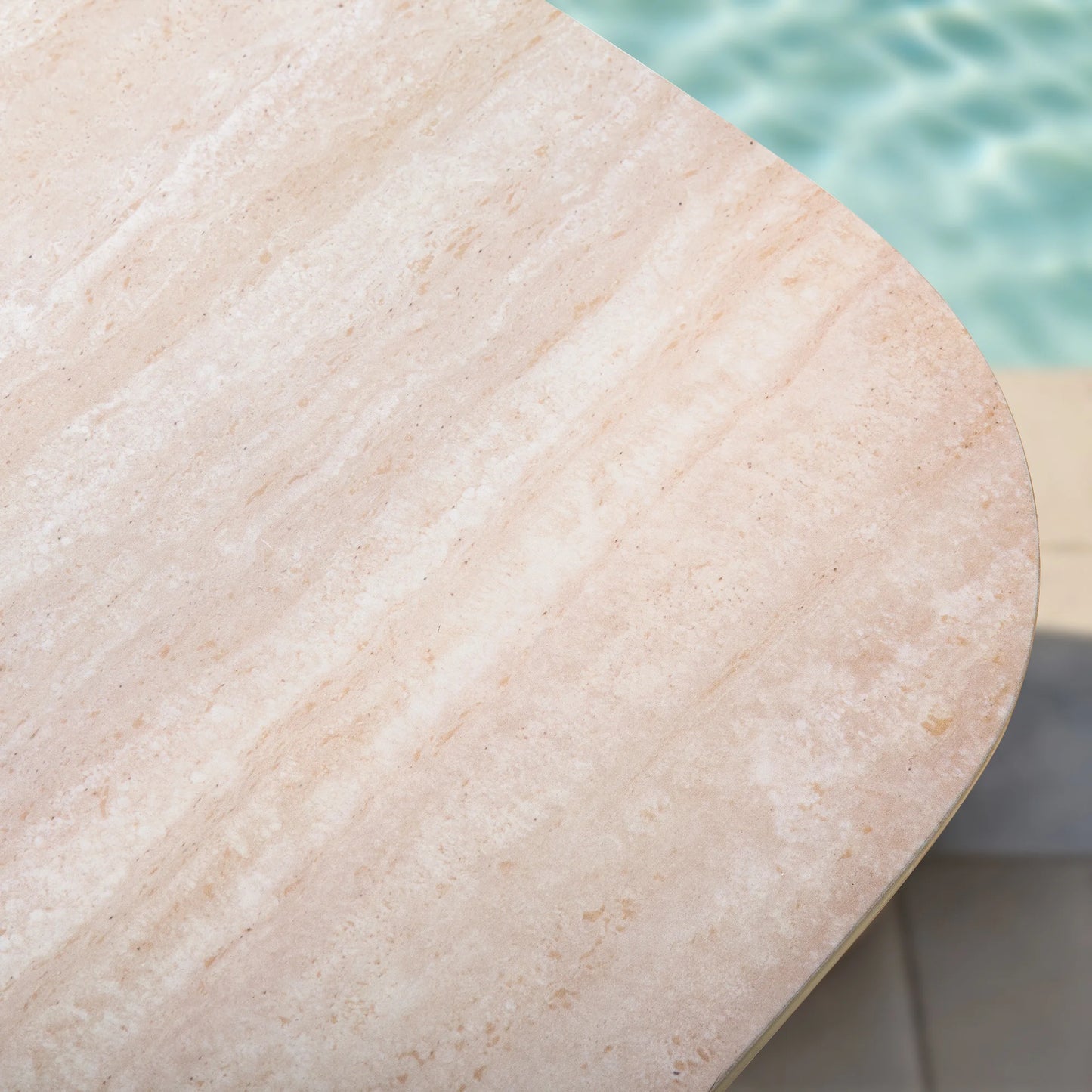 Close-up of a stone surface with a pool in the background