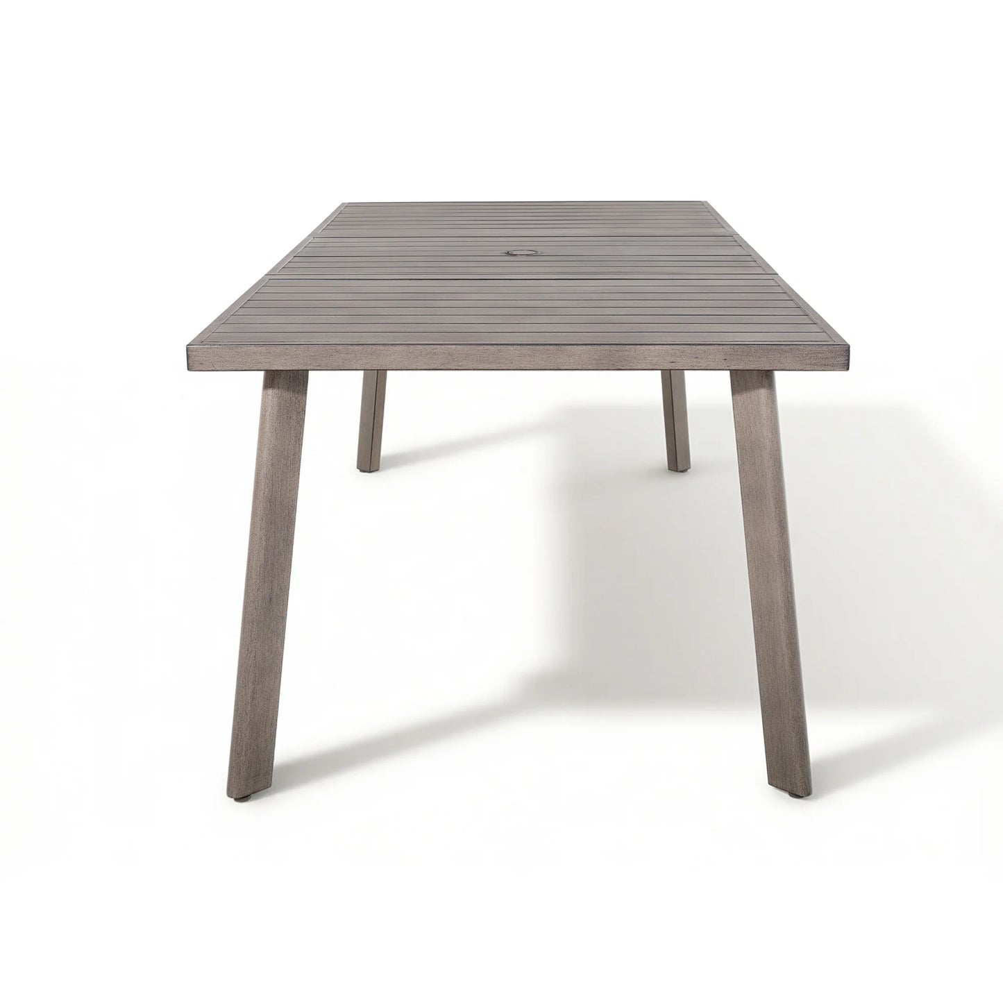 A rectangular outdoor dining table with a weathered gray-brown slatted top and four tapered legs, shown on a clean white background.
