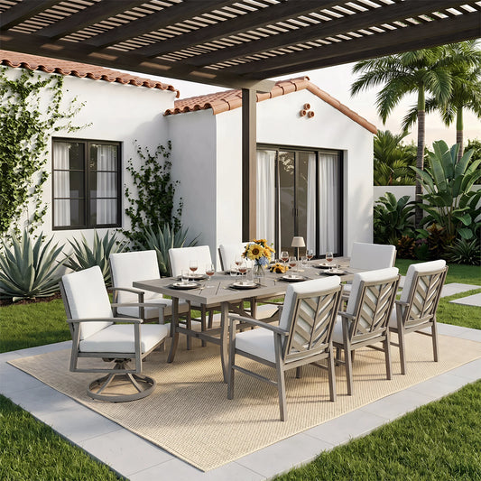 Outdoor dining set on a patio with a white house and garden in the background