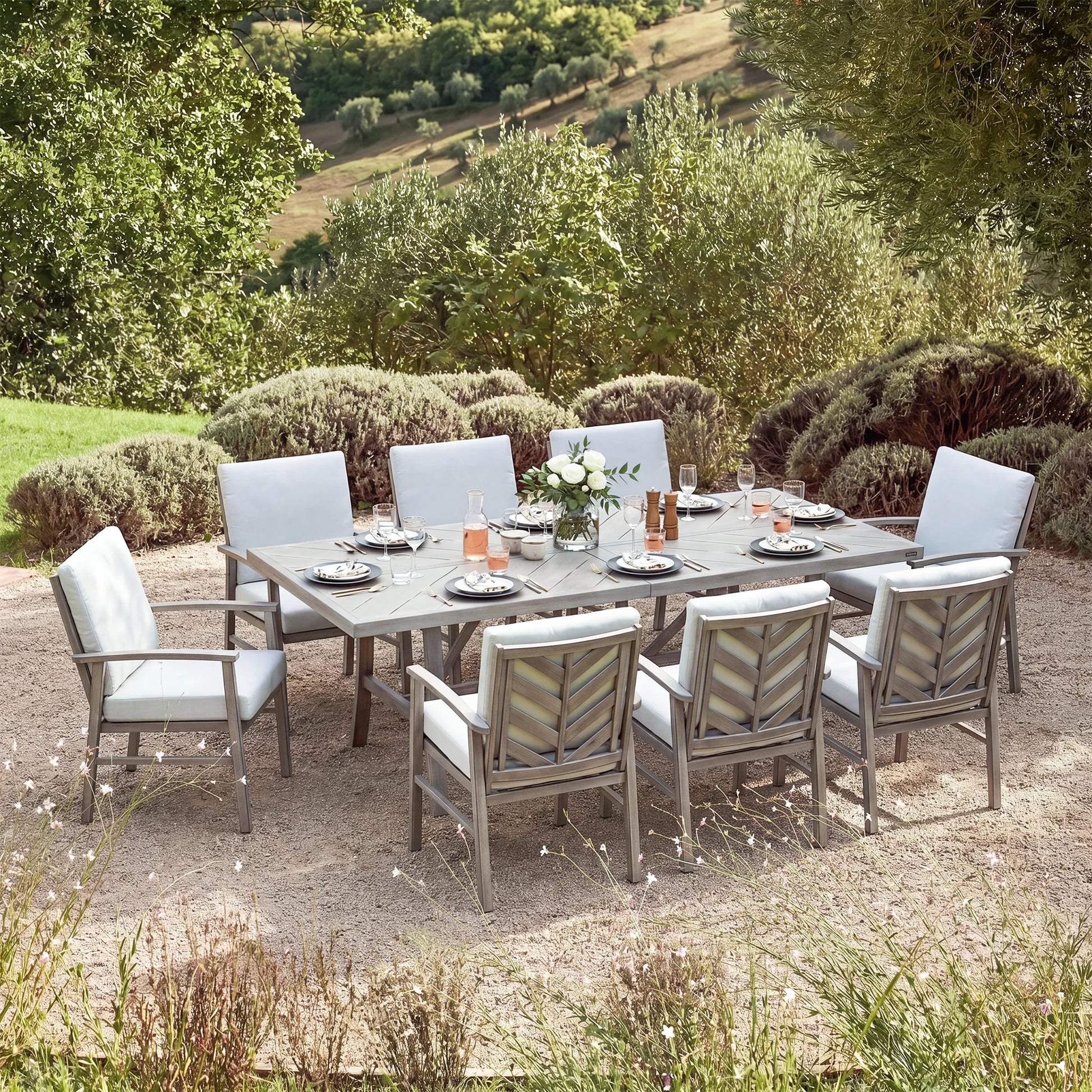 Outdoor dining set with table and chairs in a garden setting