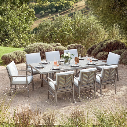 Outdoor dining set with table and chairs in a garden setting