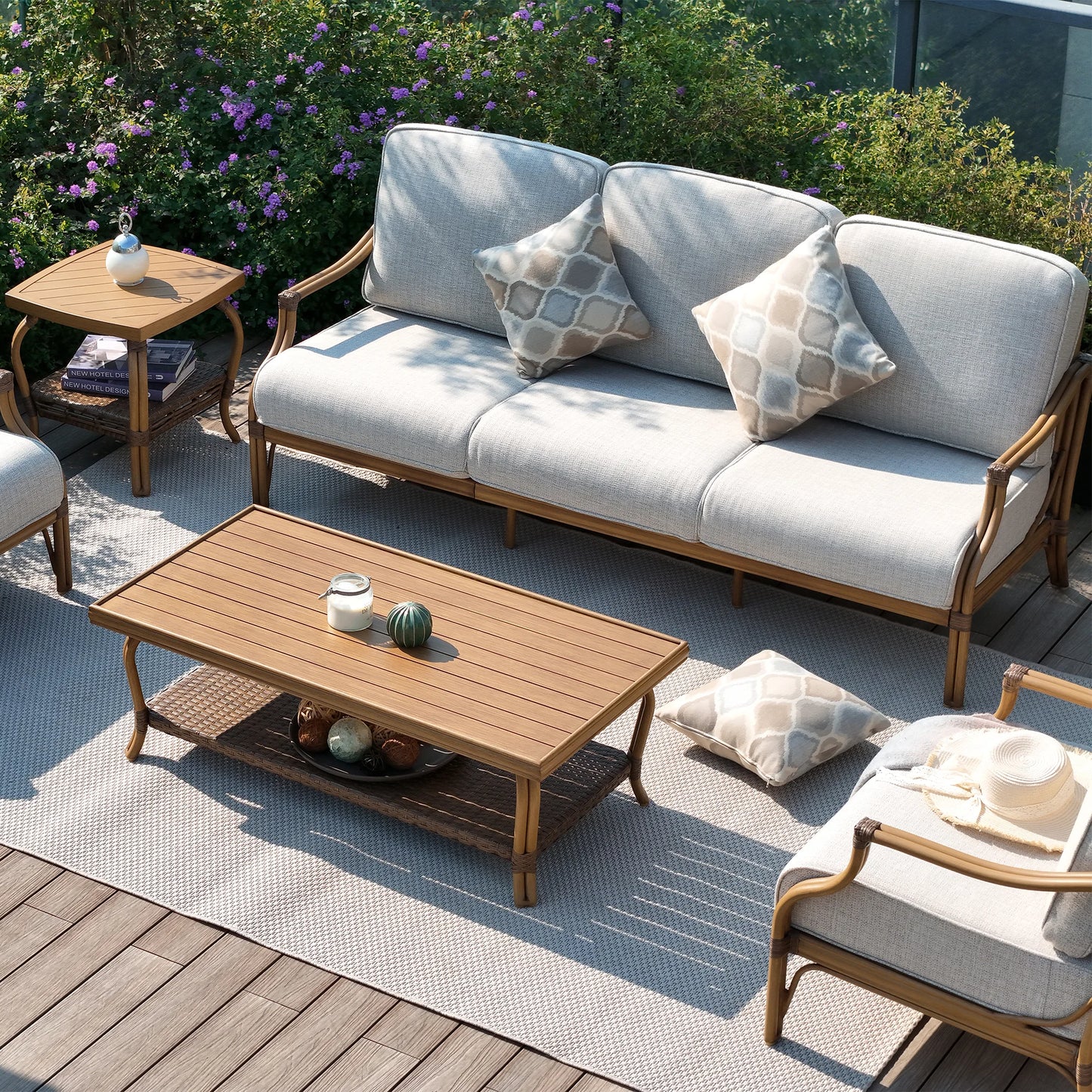 Outdoor patio set with a sofa, chairs, and coffee table on a wooden deck.