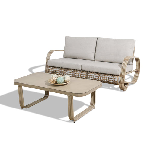 Wicker outdoor sofa with beige cushions and a matching coffee table 