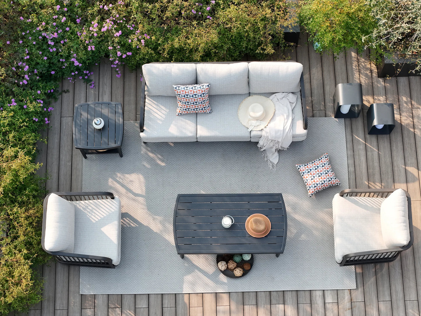 Outdoor patio set with furniture and decor on a wooden deck