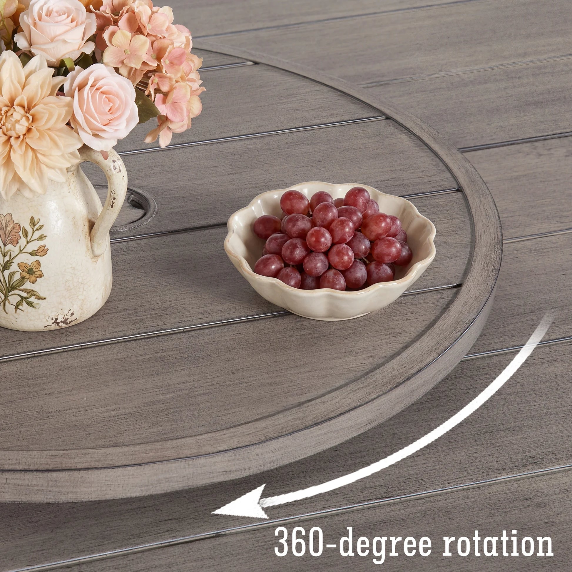 Bowl of grapes on a wooden table with flowers, indicating 360-degree rotation.