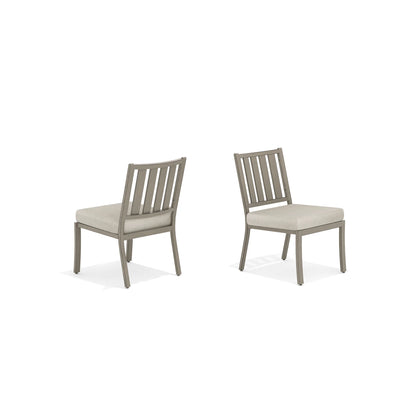 Two gray chairs with beige cushions
