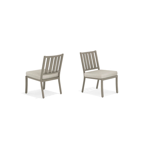 Two gray chairs with beige cushions