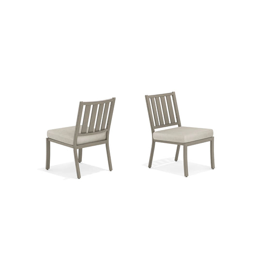 Two gray chairs with beige cushions