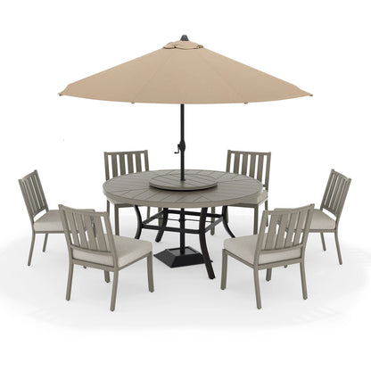 Patio dining set with round table and six chairs under a beige umbrella