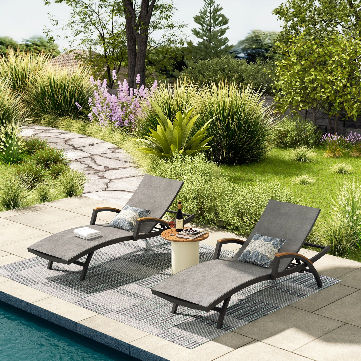 Two lounge chairs by a pool with a garden setting