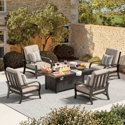 Outdoor patio set with chairs, table, and fire pit on a stone patio.