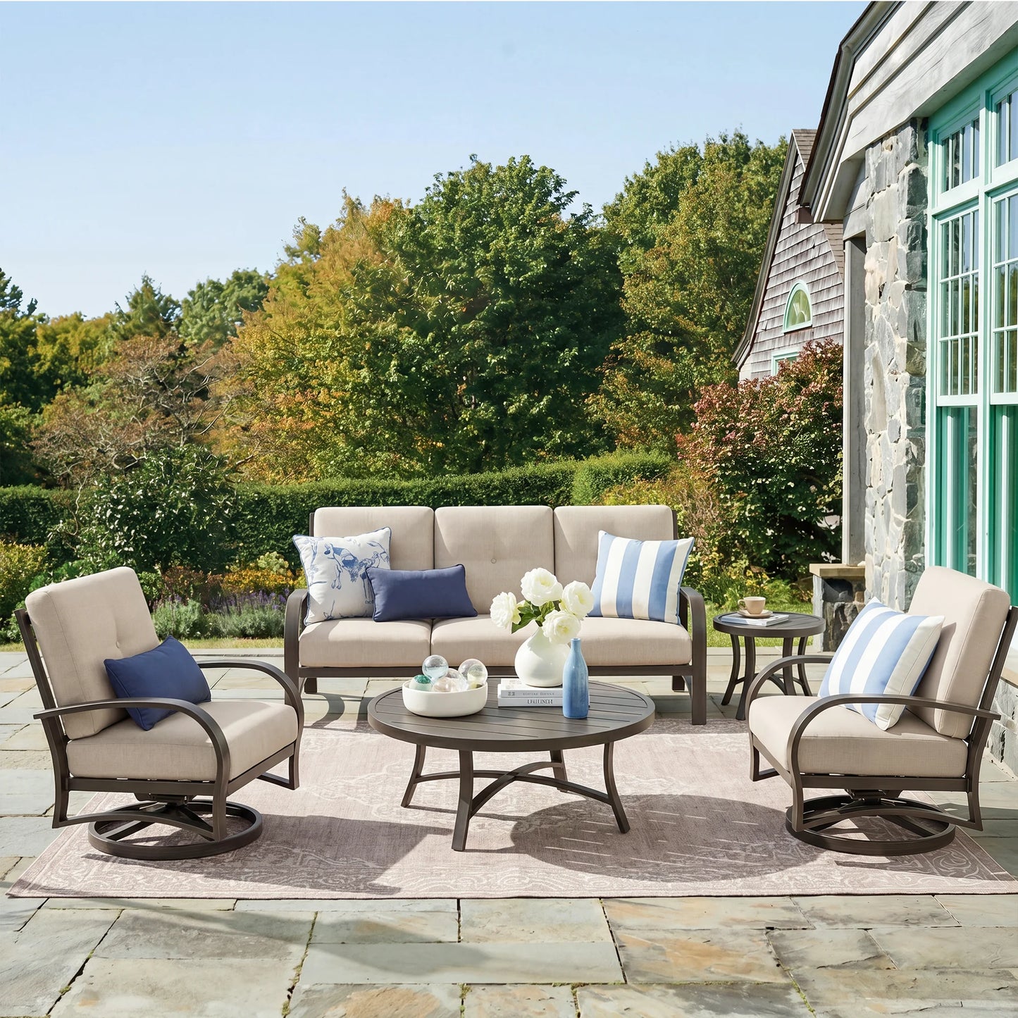 Outdoor patio set with furniture and decor on a stone patio.