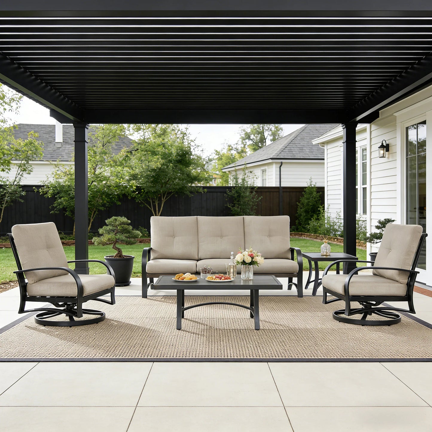 Outdoor patio set with sofa, chairs, and table under a covered area.