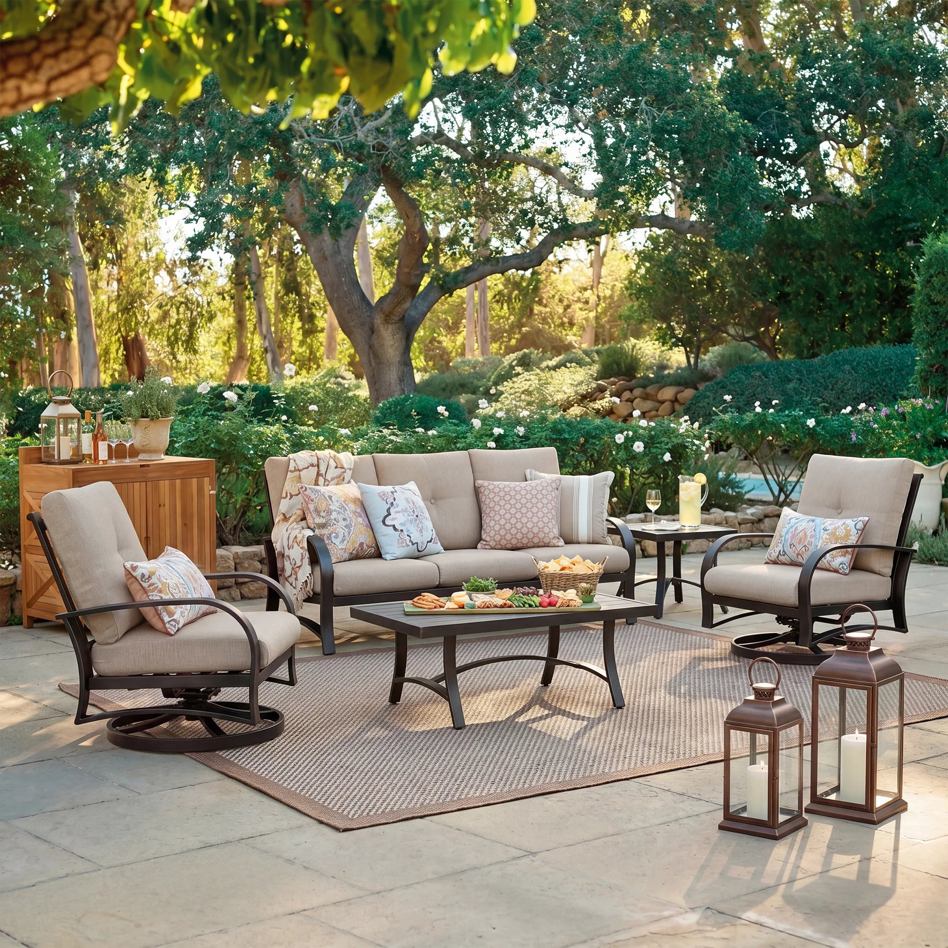 Outdoor patio setting with furniture, table, and decorative items in a garden.