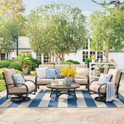Outdoor patio set with furniture and decor on a striped rug