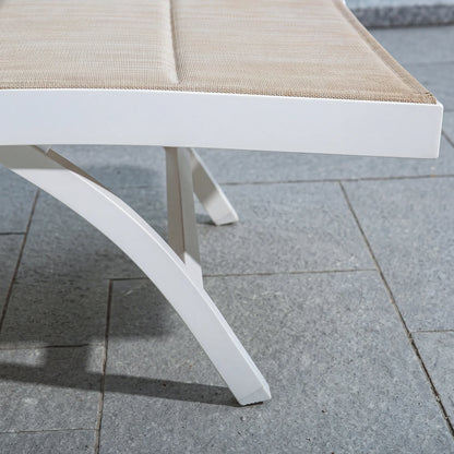 White outdoor chair with beige cushion on a tiled patio