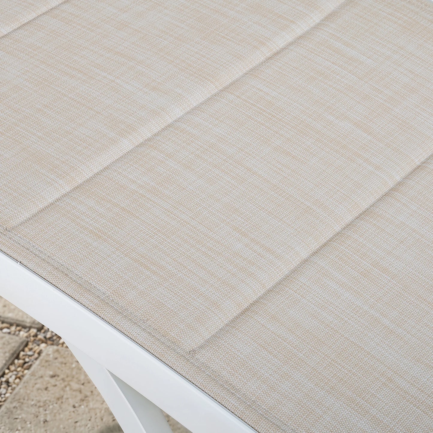 Close-up of a textured beige outdoor rug on a white surface.