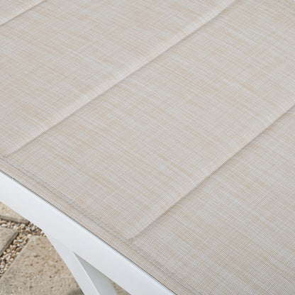 Close-up of a textured beige outdoor rug on a white surface.