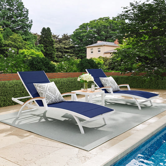 Chambray outdoor chaise lounge set beside swimming pool, curved S contour aluminum sun loungers with Phifertex fabric & quick-dry foam, teak side table on coastal backyard patio