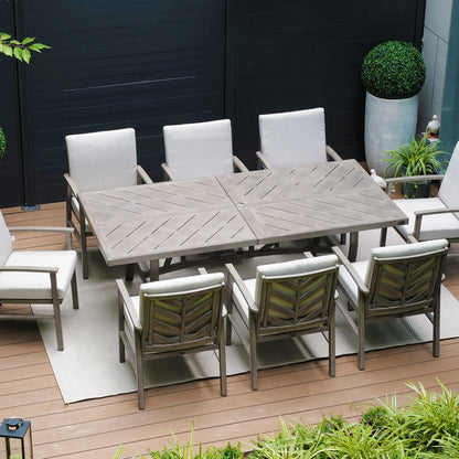 Outdoor dining set with a large table and chairs on a wooden deck.