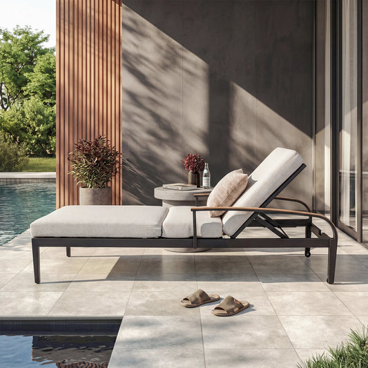 Modern outdoor lounge chair by a poolside with decorative elements.