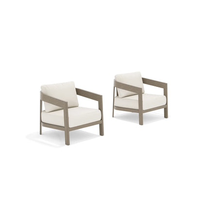 Two beige armchairs with white cushions 