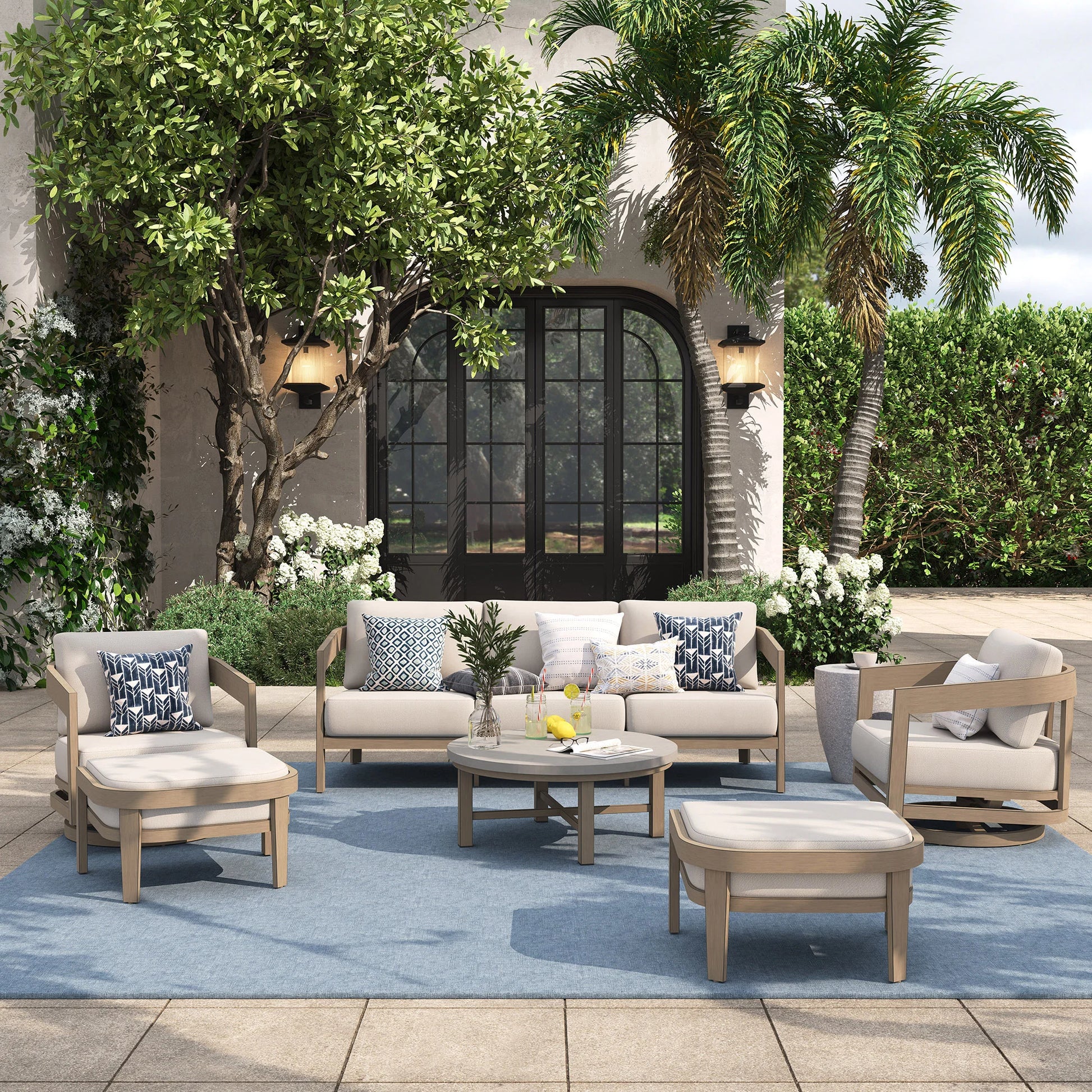 Outdoor patio set with furniture and decor in a garden setting