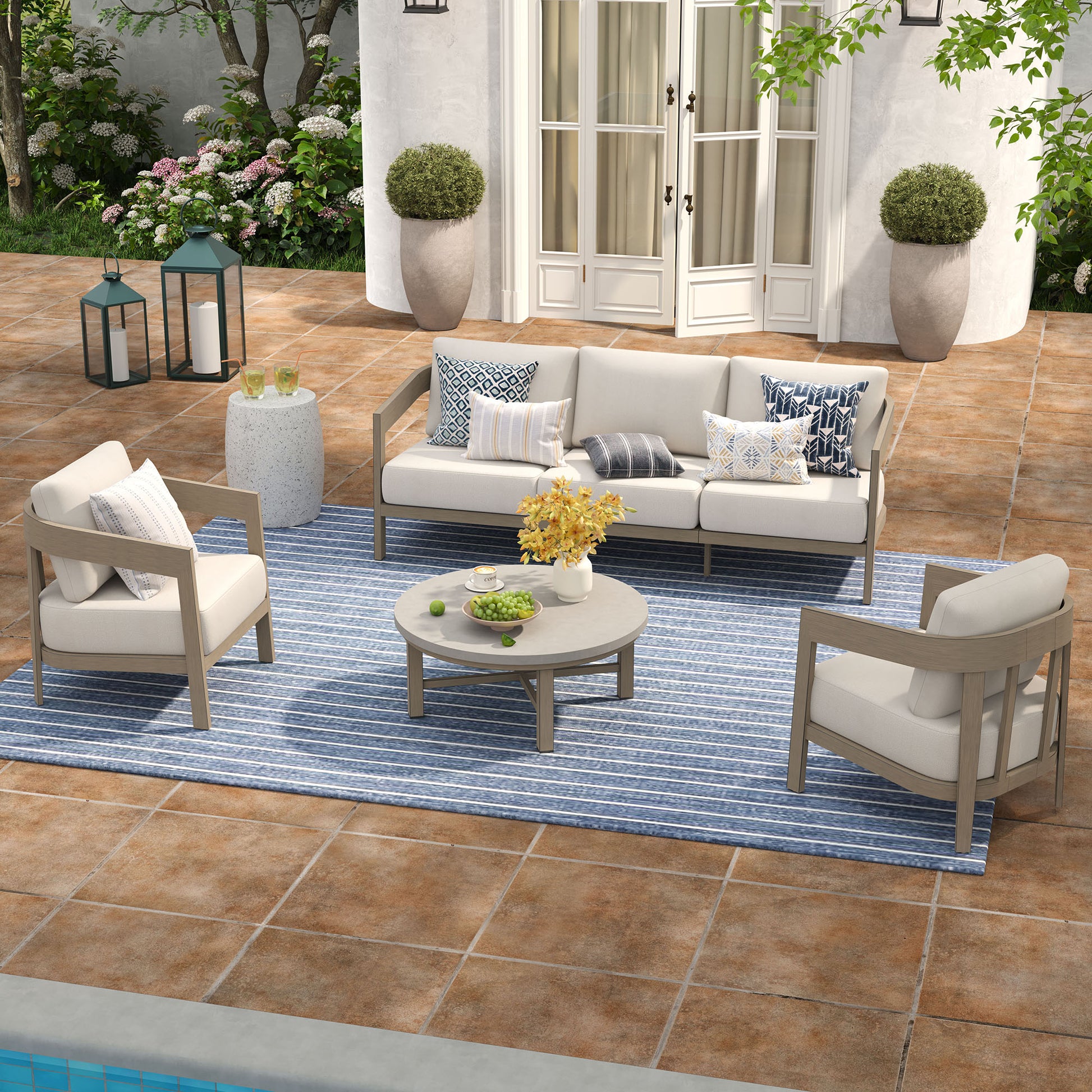 Outdoor patio set with furniture and decor on a tiled patio.