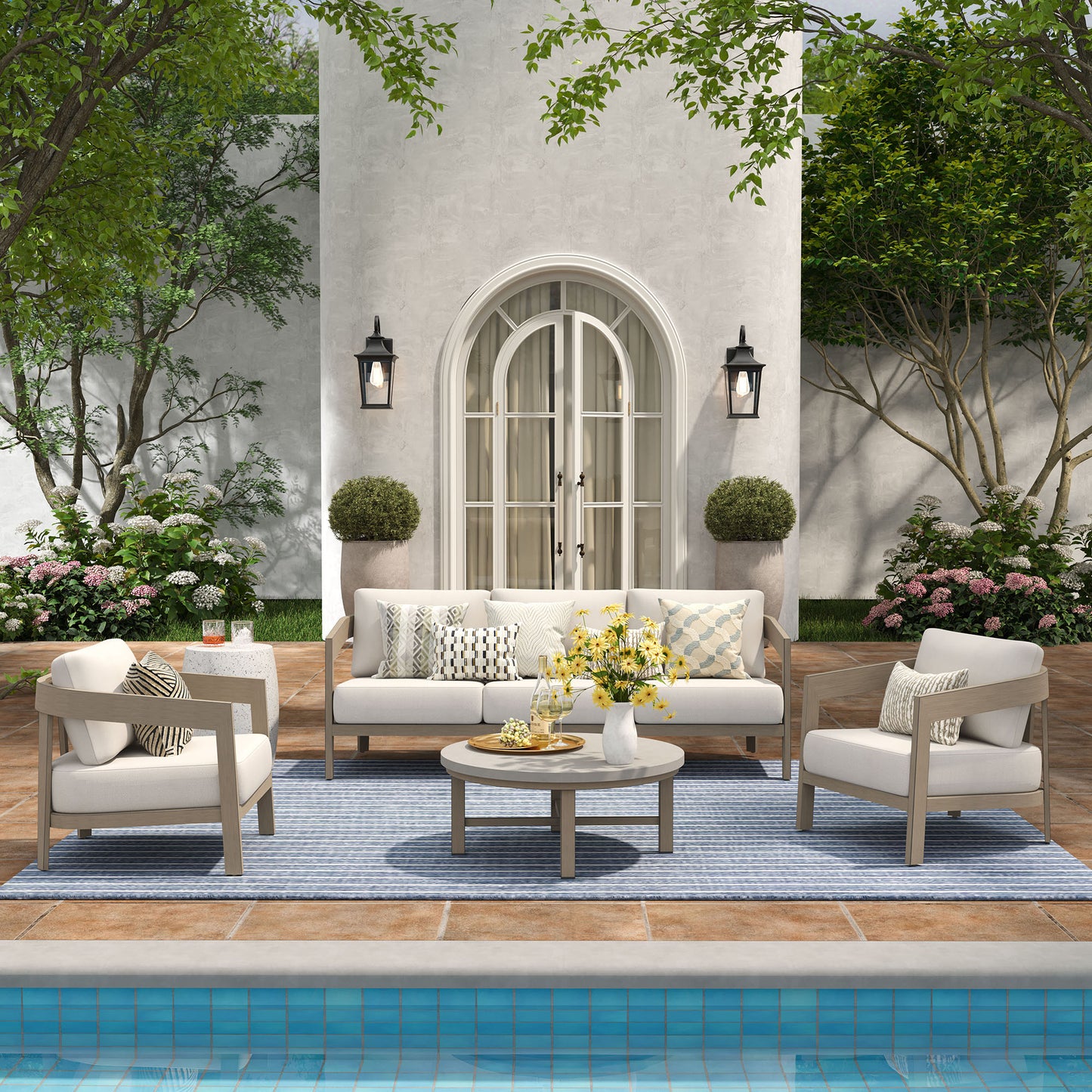 Outdoor patio set with white furniture by a poolside