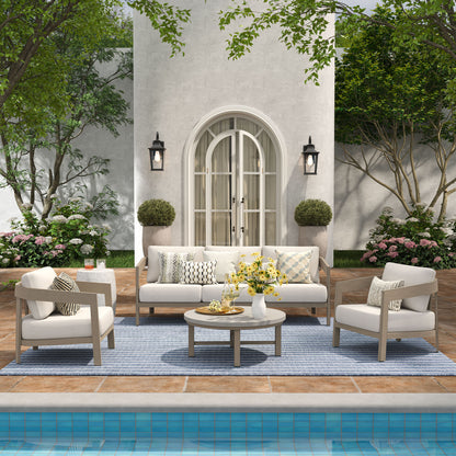 Outdoor patio set with white furniture by a poolside