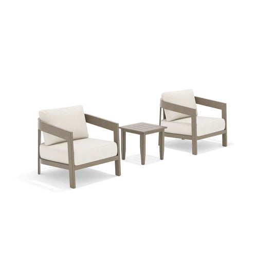 Two wooden armchairs with light beige cushions and a matching side table 