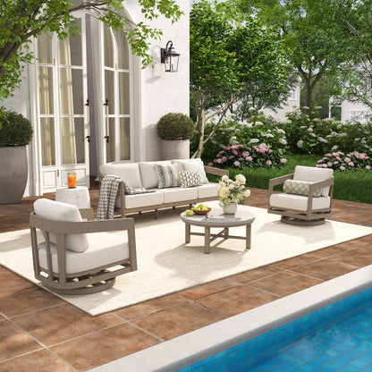 Outdoor patio with furniture, table, and decorative elements near a pool.