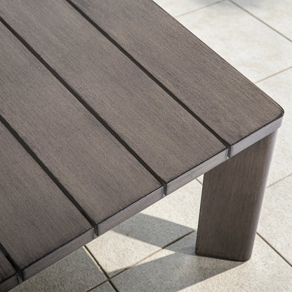 Extreme close-up of the slatted tabletop showing the exquisite hand-brushed wood-grain painted finish on the durable aluminum frame.